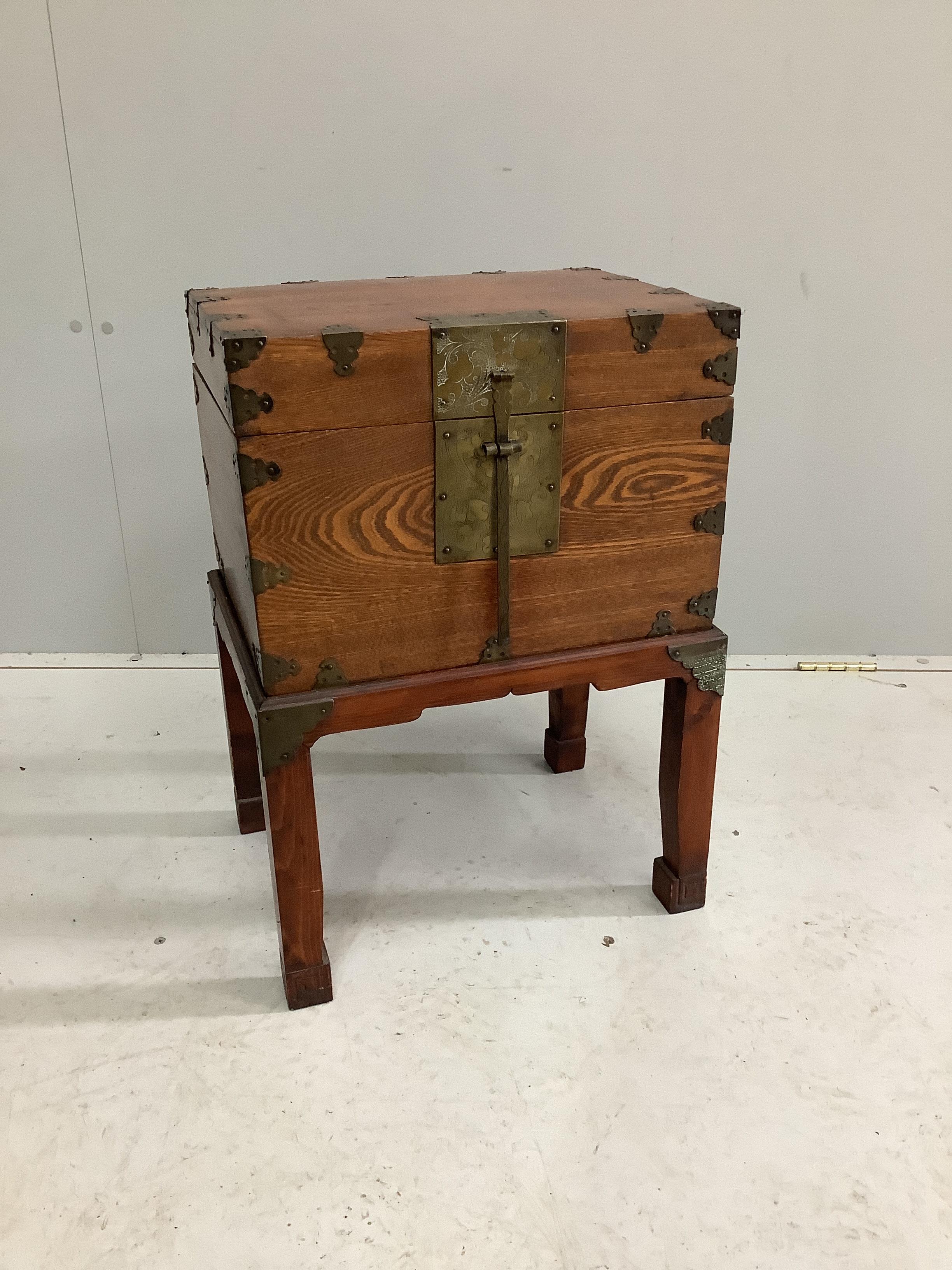 A Chinese brass mounted elm box on stand, width 42cm, depth 32cm, height 59cm